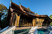 Wat Xieng Thong temple in Luang Prabang, Laos.  A view of the 'sim' with the large sweeping roof. 